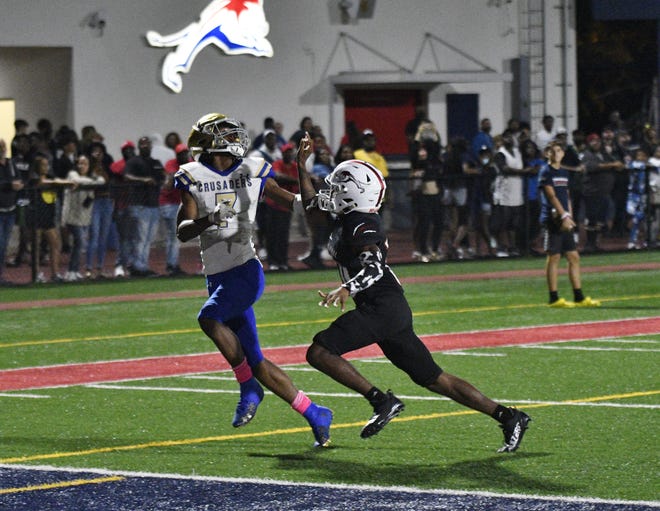 Crusaders receiver Kevin Levy tries to track down a back-shoulder fade against man coverage during the second half of Friday's 3A regional final against Chaminade-Madonna.