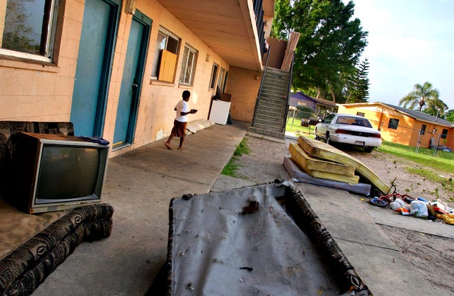 Workers for the owners of Gifford Gardens leave the belongings of ex-tenants piled in the main courtyard of the complex for days before removing them on March 31, 2005.  Many tenants are leaving the complex due to poor living conditions, such as leaks, mold and mildew, over-flowing trash, and cockroach infestation. Others claim that the lack of affordable housing leaves them without other options.