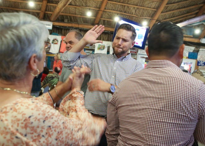State Rep. John Snyder celebrates as Amy Pritchett (left), a Martin County School Board member, informs him he won his reelection to the House District 86 seat on Tuesday, Nov. 8, 2022, at Harry and the Natives in Hobe Sound. Snyder beat his Democratic challenger Ray Denzel. "I predict it's not going to be a red wave tonight, it's going to be a red tsunami," said Snyder during his acceptance speech. "We are going to send a message to the rest of the country, that's why the democrats have already raised a white flag they don't want to even play here in Florida because this is a place for liberty and we are keeping Florida free. We've got a lot of work ahead of us over the next two years."