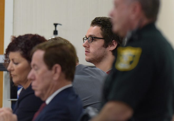 Austin Harrouff (background) sits with his legal team in court before Circuit Judge Sherwood Bauer at the Martin County Courthouse on Monday, Nov. 28, 2022 in Stuart. Harrouff was found not guilty by reason of insanity for killing John Stevens III, 59 and Michelle Mishcon, 53, during a brutal attack Aug. 15, 2016 at their home on Southeast Kokomo Lane in southern Martin County.