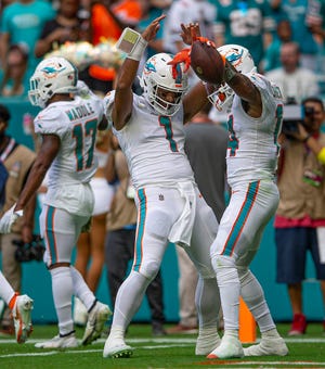 Dolphins quarterback Tua Tagovailoa (1) and receiver Trent Sherfield celebrate after connecting on a touchdown pass against the Browns late in the first half on Sunday.