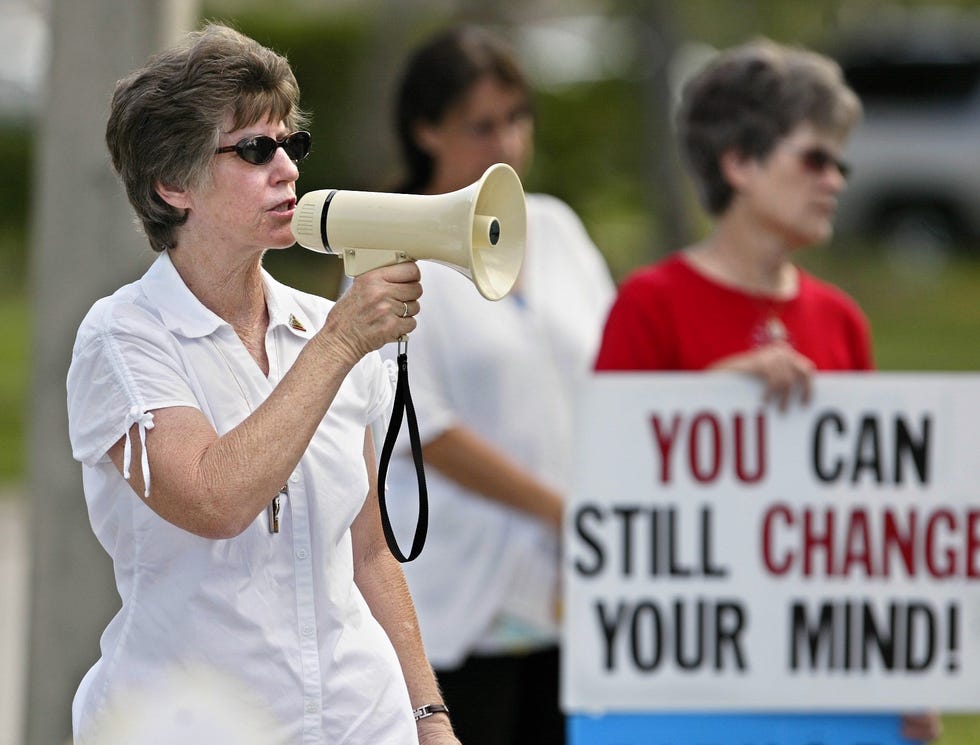 Jean Seelinger of North Palm Beach yells at women entering the Presidential Women's Center in West Palm Beach in 2005. She told the women to look at the sonograms of their sons or daughters, to think about adoption instead of abortion, that they were there to help them.