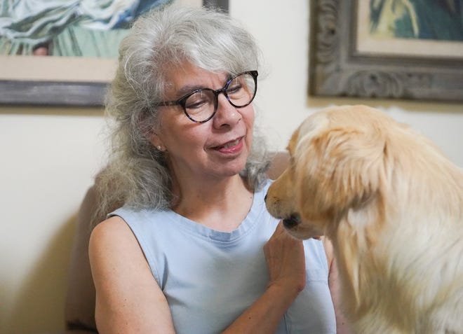 Cassandra Chan pets her one-year-old golden retriever Abby Wednesday, Oct. 12, 2022, at her home in Port St. Lucie. Chan's deceased dog Maisie, a 2-year-old St. Bernard-poodle mix, had to be euthanized after taking her to the Humane Society of St. Lucie County for a routine spaying operation. According to Chan, the veterinarian assigned to perform the procedure was under the influence of alcohol or drugs. Instead of tying off Maisie's reproductive organs, the vet apparently severed the dog's small intestine.