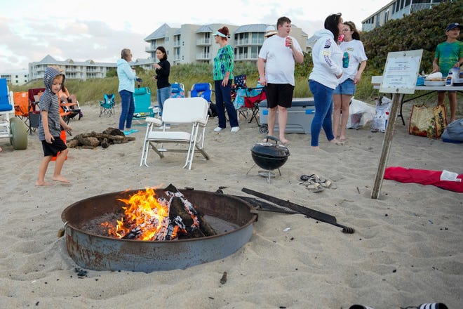 Beachgoers enjoy fire pits at Stuart Beach on Sunday, Feb. 20, 2022, on Hutchinson Island in Martin County. Beach fires can be held at designated fire pits from November to February with a permit purchased through Martin County Parks and Recreation.