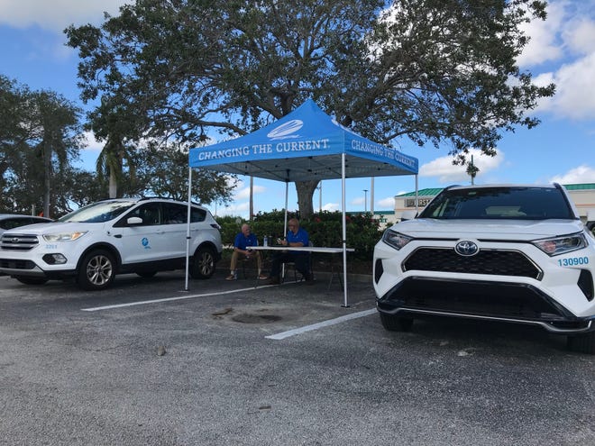 A Florida Power & Light tent and vehicles set up in the Miracle Mile shopping corridor of Vero Beach  served as what the company calls an "outage relief site" where residents without power can charge devices, access Wi-Fi and speak with its "community response team," said FPL spokesperson Peter Robbins.