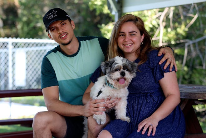 Hector Hernandez with his girlfriend Gabriella Gonzalez and their dog, Coco, in Fort Pierce on Tuesday, Oct. 25, 2022. The couple embarked on a 22-day journey to the U.S., caravanning through Nicaragua, Honduras, Guatemala and Mexico, leaving their friends and family behind in Cuba.