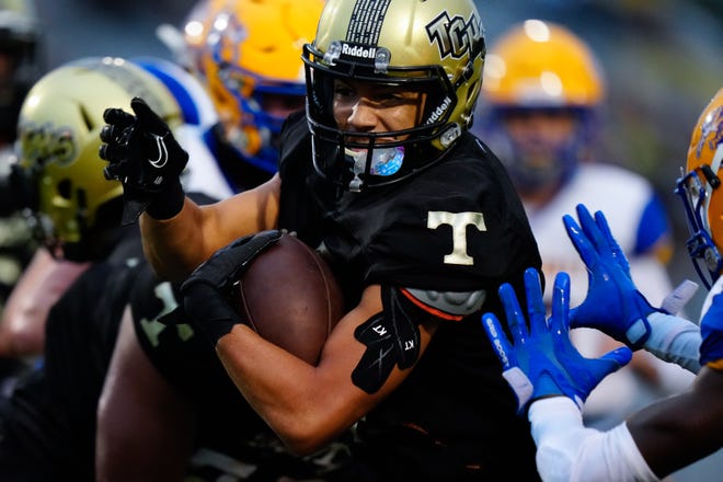 Treasure Coast High School’s quarterback George Roberts (4) runs the ball against Martin County High School in a high school football game on Friday, Sept. 16, 2022 at Lawnwood Stadium in Fort Pierce. Treasure Coast won 28-7 after the game was shortened due to weather.