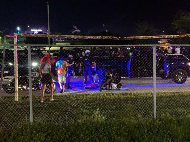 Emergency personnel provide medical assistance to an individual in the aftermath of a shooting in the parking lot at a high school football game between Wekiva and Jones in Orlando on Saturday, Nov. 12, 2022.
