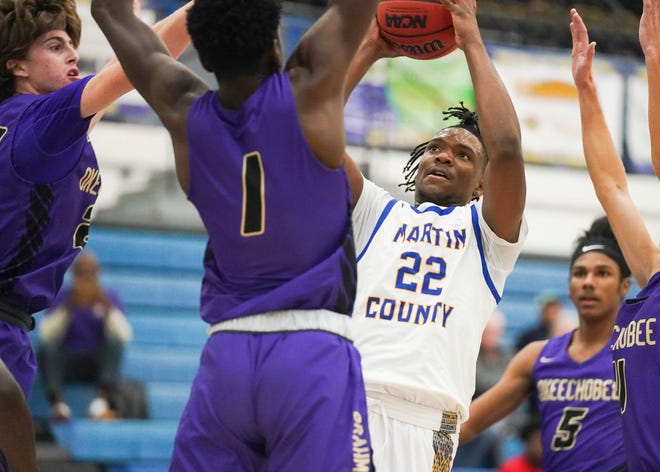 Martin County's Elijah Duval (22) goes for a basket as Okeechobee defends in a high school boys basketball game on Tuesday, Nov. 30, 2021, in Stuart.