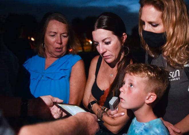 Debbie Brannam (left), Rachel Thomas (middle), Brixton Thomas, 8, all of Penryn, Calif., and Stacy Thomas, of Jacksonville, discuss what is seen in a photo taken by Jim Wilson, a local expert on the Plate Fleet of 1715 that sank off the Treasure Coast, during the "Vero Beach Beachside Historical Ghost Walk" along Ocean Drive on Wednesday, Sept. 22, 2021. "The walk is the history of mainly Vero Beach and the Treasure Coast. We talk about the paranormal phenomenon that my group has experienced or legend has talked about," said tour guide Larry Lawson, a paranormal investigator and owner of Indian River Hauntings.