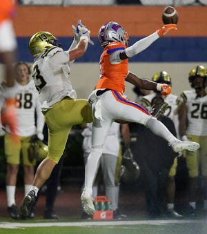 Bolles Bulldogs' Kavon Miller (3) breaks up a pass intended for Bishop Moore's Mylan Bowen (13) during late first-quarter action. The Bulldogs hosted Orlando's Bishop Moore Hornets at Skinner-Barco Stadium in Jacksonville on Nov. 18.