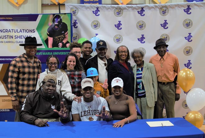 John Carroll Catholic cornerback Aidan Singleton signed with Lehigh on National Signing Day and celebrates with his family in a ceremony in the school's gymnasium on Friday, Dec. 23, 2022 in Fort Pierce.