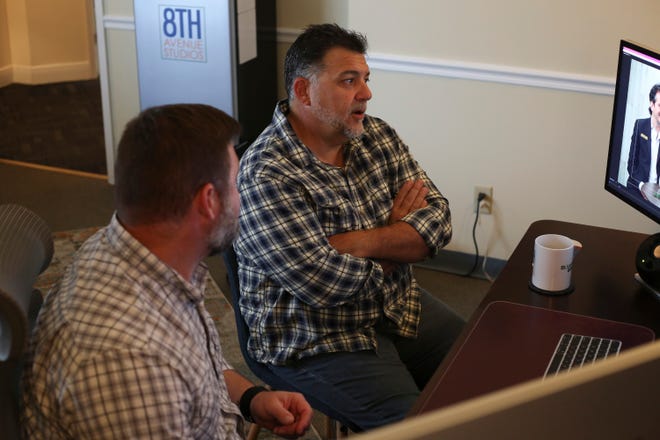 Creative Director Bryan Smith and radio personality Daniel Russo, reviews edits to a podcast at the 8th Avenue Studios in Port St. Lucie on Monday, Nov. 21, 2022. Russo, a local radio personality, is hosting the “Don’t Come Here” podcast for the Treasure Coast.