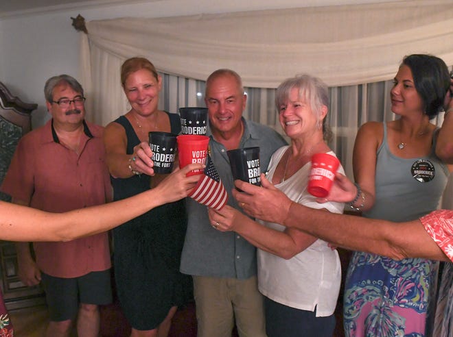 Michael Broderick (right from center) and his wife Katy share a toast with his supporters at a friends house for a runoff election with his opponent James Clasby for the City of Fort Pierce Commission District 2 race, on Tuesday, Aug. 23, 2022, in Fort Pierce. Broderick and Clasby will face off in the general election to succeed 12-year Fort Pierce City Commissioner Tom Perona.
