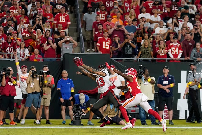 Tampa Bay Buccaneers wide receiver Mike Evans (13) makes a touchdown reception against Kansas City Chiefs cornerback Jaylen Watson (35) during the first half of an NFL football game Sunday, Oct. 2, 2022, in Tampa, Fla. (AP Photo/Chris O'Meara)
