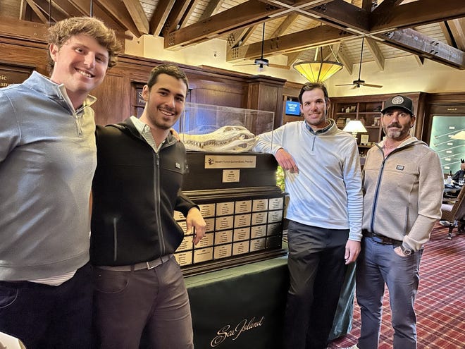 The winning team in the 46th annual Henry Tuten Gator Bowl Pro-Am displays the new trophy that was debuted at the Sea Island Golf Club. From the left are Andrew McLauchlan of Neptune Beach, Scott Kennon of Ponte Vedra Beach, Tee-K Kelly of St. Simons Island, Ga., and Scott Riley of Jacksonville.