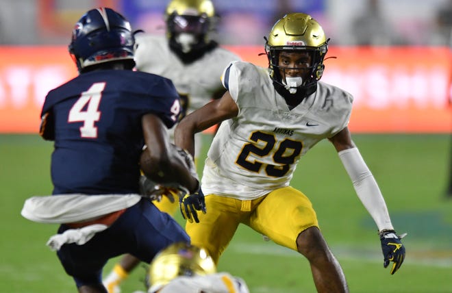 Conrad Hussey (29) of St. Thomas closes in for a tackle as John Ponder (4) of Tampa Bay Tech looks for running room  during second quarter of the Class 7A state championship game at DRV PNK Stadium, Fort Lauderdale, FL  Dec. 17, 2021.