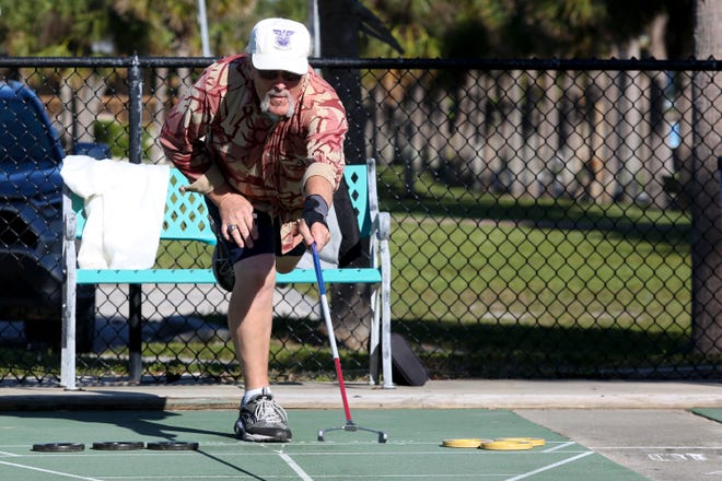 Keith Morton, of Sebring, plays a game of shuffleboard during a two-day shuffleboard tournament hosted by the Florida Shuffleboard Association on Monday, Dec. 19, 2022, in Fort Pierce. Thirty-eight shuffleboard players gathered near the River Walk Center in downtown Fort Pierce for the tournament. The retirees played on the courts with a view of the Indian River Lagoon during the tournament Monday morning, competing against players from as far away as Fort Myers.