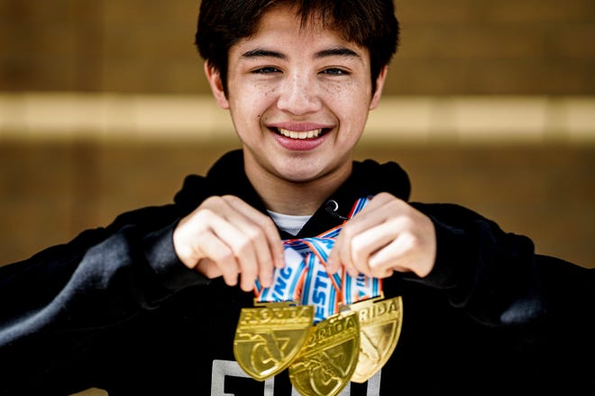 Jensen Beach High School freshman Sebastian Degennaro holds his medals during a homecoming celebration Monday, March 7, 2022, at Jensen Beach High School. A school record was broken with nine Jensen Beach wrestlers reaching the podium to win the FHSAA State Wrestling Championship, held in Kissimmee.
