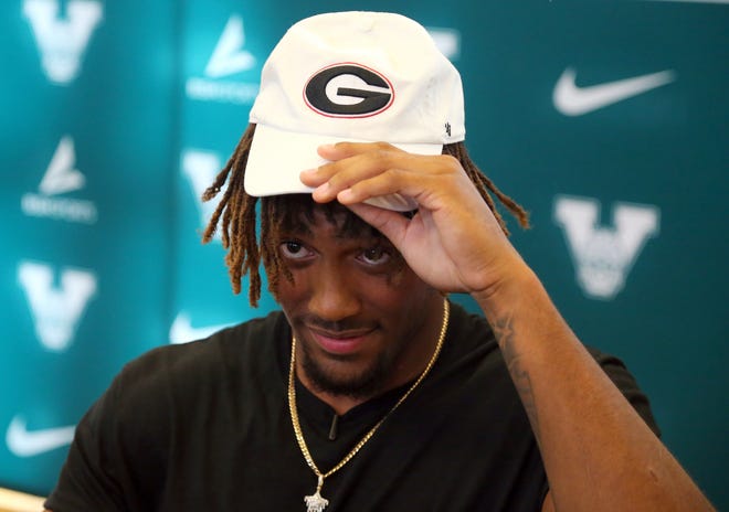 Venice High defensive end Damon Wilson adjusts his cap after he announced he would attend the University of Georgia.