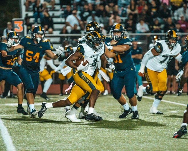 Mark Fletcher of American Heritage runs the ball against Naples on Friday night, Oct. 12, 2022, at Naples High School. Fletcher picked Miami over Florida on Sunday.