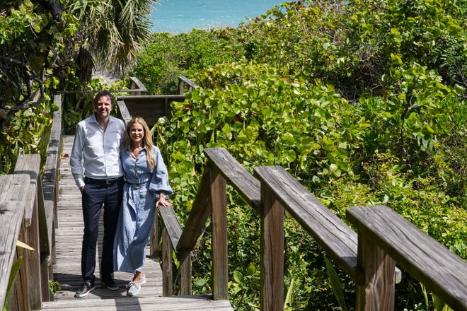 Dr. Marc (left) and Janna Ronert stand to the left of the piece of land where they want to build a beach house on the east side of South Beach Road on Wednesday, March 9, 2022, in Jupiter Island. The couple has faced fierce backlash after submitting development plans to the town of Jupiter Island to build the beach house. The backlash has spiraled into lawsuits and alleged conspiring between neighbors and former public officials who are resisting additional development in the neighborhood. "The beach house is objected by the neighbors," said Marc. "We are fully compliant with every state regulation and the department of environmental protection gave us the green light and they didn't see any objection and the city OK'd it. We are within the building code but the neighbors chose to appeal the decision." The couple's main residence is under construction on the west side of South Beach Road.