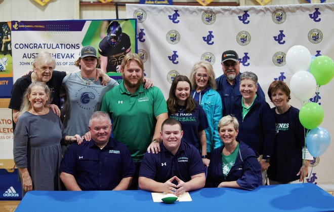 John Carroll Catholic offensive lineman Austin Shevak signed with Ave Maria on National Signing Day and celebrates with his family in a ceremony in the school's gymnasium on Friday, Dec. 23, 2022 in Fort Pierce.