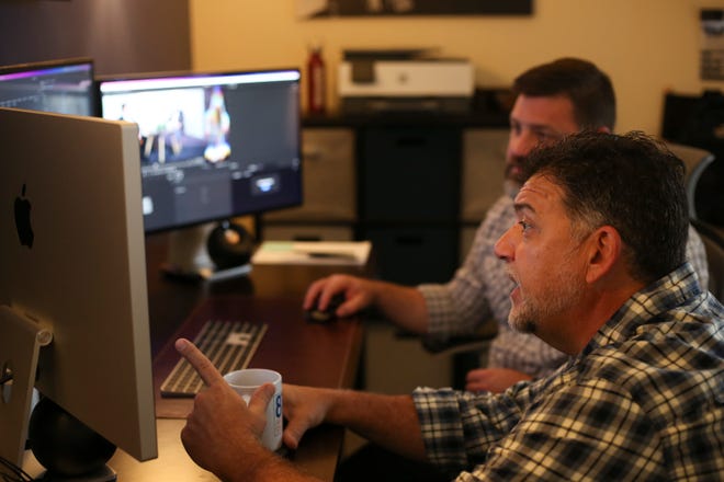 Creative Director Bryan Smith and radio personality Daniel Russo, reviews edits to a podcast at the 8th Avenue Studios in Port St. Lucie on Monday, Nov. 21, 2022. Russo, a local radio personality, is hosting the “Don’t Come Here” podcast for the Treasure Coast.