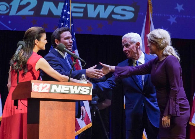 Florida's Republican incumbent Gov. Ron DeSantis and Charlie Crist, a former governor, take the stage at Sunrise Theatre for their only scheduled debate, Monday, Oct. 24, 2022, in Fort Pierce.
