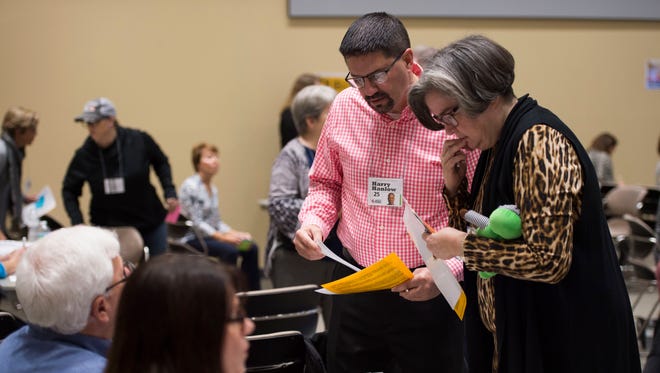 Stuart Police Chief David Dyess (left) and Martin County School Board Chair Christia Li Roberts, acting as a young dating couple with a child, visit the mortgage and realty booth during Dare to Care: A Poverty Simulation on Wednesday, Jan. 17, 2018 at the Indian River State College Chastain Campus in Stuart. Dyess participated "to get a better understanding of the needs of those in need," a practice he said will use when encountering people when he is on duty. Other volunteer participants, totaling about 75 people, included commissioners, law enforcement officers, religious leaders and other local dignitaries. The event was hosted by House of Hope, Martin County Community Foundation, Mary's Shelter, and the United Way of Martin County. "There's a perception that poverty doesn't exist in Martin County," said Lauren Mustelier, House of Hope volunteer manager, even though 41 percent of Martin County households earn less than $26,689 per year, according to the United Way ALICE Report.