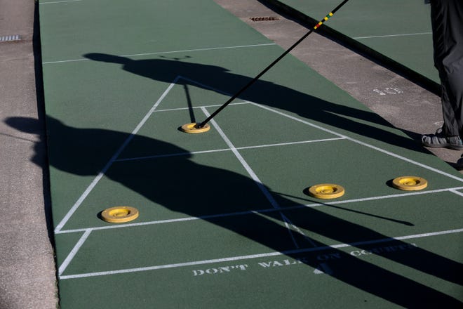 Thirty-eight shuffleboard players gathered near the River Walk Center in downtown Fort Pierce on Monday, Dec. 19, 2022, for a two-day tournament hosted by the Florida Shuffleboard Association. The retirees used a little over half of the courts with a view of the Indian River Lagoon during the tournament Monday morning, competing against players from as far away as Fort Myers.