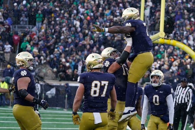 Notre Dame running back Audric Estime (7) celebrates with offensive tackle Joe Alt (76) after scoring a touchdown against Boston College on Nov. 19.
