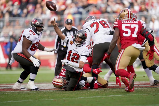 Tampa Bay Buccaneers quarterback Tom Brady (12) throws an incomplete pass while being tackled by San Francisco 49ers defensive end Nick Bosa (97) in the first quarter at Levi's Stadium.