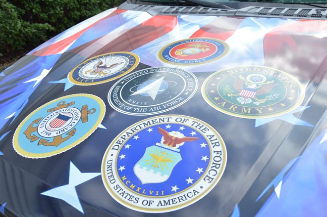 Images of the seals of the six branches of the U.S. armed forces were printed across the hood of the Indian River County Sheriff's Office "PTSD Awareness" patrol truck which was unveiled Nov. 1, 2022.