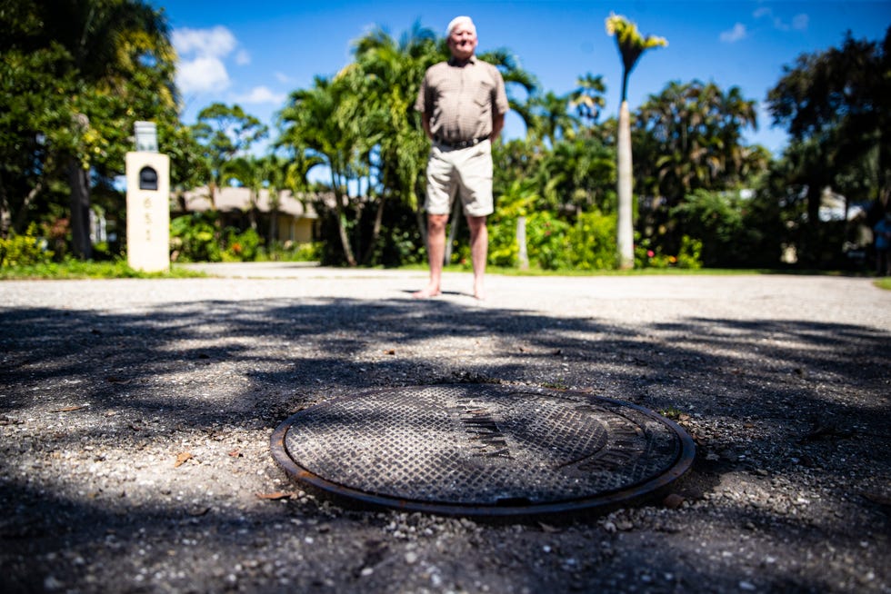 Frank Boudreault stands next to a manhole cover in his Fort Myers neighborhood that he says spews raw sewage every time it rains four inches or more. The runoff and sewage then drains into the Caloosahatchee River. He says he has called the city numerous times for help and was told to call a plumber.