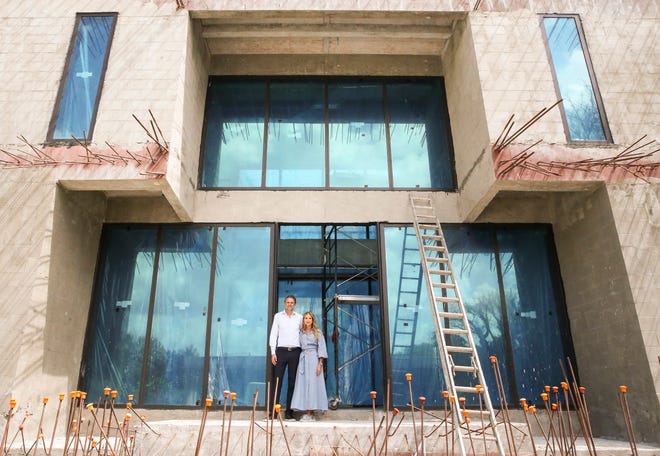 Dr. Marc (left) and Janna Ronert stand in the doorway of their main residence that is under construction on the west side of South Beach Road on Wednesday, March 9, 2022, in Jupiter Island. The couple has faced fierce backlash after submitting development plans to the town of Jupiter Island to build a beach house on the east side of South Beach Road. The backlash has spiraled into lawsuits and alleged conspiring between neighbors and former public officials who are resisting additional development in the neighborhood. "The beach house is objected by the neighbors," said Marc. "We are fully compliant with every state regulation and the department of environmental protection gave us the green light and they didn't see any objection and the city OK'd it. We are within the building code but the neighbors chose to appeal the decision."