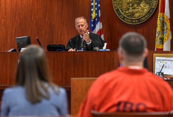 Judge Dan Vaughn (center) gestures towards murder suspect Michael Jones (right) and Assistant Public Defender Dorothy Naumann, on Monday, Sept. 23, 2019, at the Indian River Courthouse in Vero Beach, while presiding on a hearing over the use of photos of the crime scene and autopsy of murder victim Diana Duve for Jones's upcoming trial.