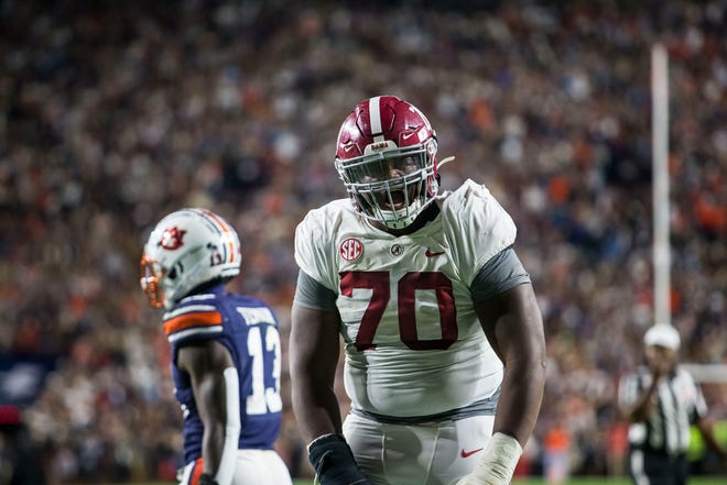 Alabama offensive lineman Javion Cohen (70) celebrates scoring to tie the game at 10-10 during the second half of an NCAA college football game, Saturday, Nov. 27, 2021, in Auburn, Ala. (AP Photo/Vasha Hunt)