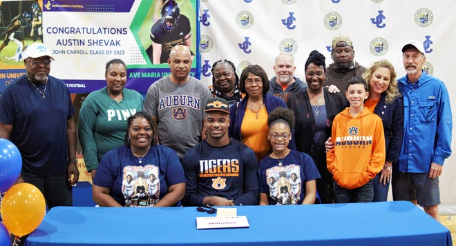 John Carroll Catholic defensive lineman Wilky Denaud signed with Auburn on National Signing Day and celebrates with his family in a ceremony in the school's gymnasium on Friday, Dec. 23, 2022 in Fort Pierce.