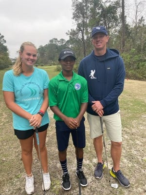 Kaitlyn Schroeder of Jacksonville (left), who will enroll at Alabama in January and her father, University of North Florida golf coach Scott Schroeder, flank Moore-Myers Childrens Fund member Coleman Spencer.