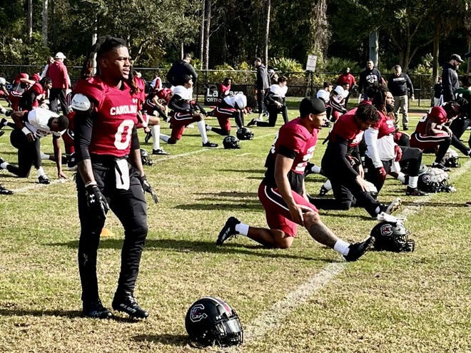 South Carolina running back Juju McDowell stretches with his teammates at Ponte Vedra High School on Dec. 26 before the Gamecocks conducted their first practice of TaxSlayer Gator Bowl week.
