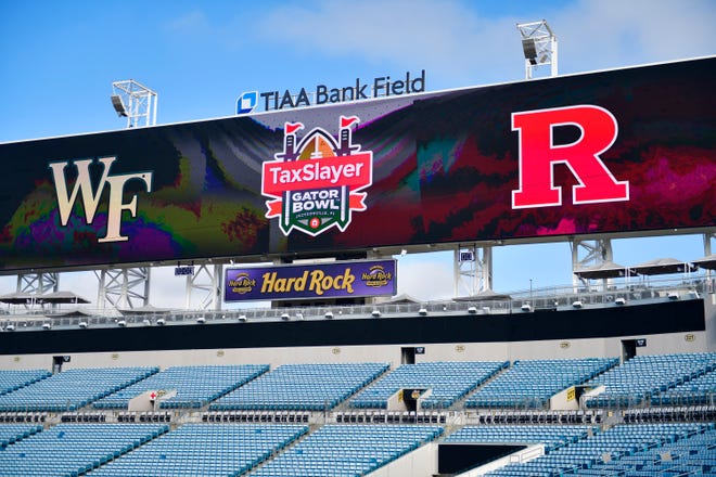 The scoreboard in last year's TaxSlayer Gator Bowl shows the participants, Wake Forest and Rutgers. South Carolina and Notre Dame play in this year's game on Friday.
