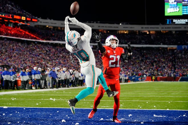 Dec 17, 2022; Orchard Park, New York, USA; Miami Dolphins wide receiver Tyreek Hill (10) attempts to catch a pass for a touchdown against Buffalo Bills safety Jordan Poyer (21)  during the first half at Highmark Stadium. Mandatory Credit: Gregory Fisher-USA TODAY Sports