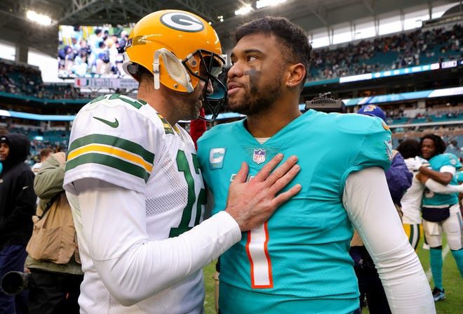 Aaron Rodgers of the Green Bay Packers hugs Tua Tagovailoa of the Miami Dolphins on the field after the game at Hard Rock Stadium on Dec. 25, 2022, in Miami Gardens, Florida.