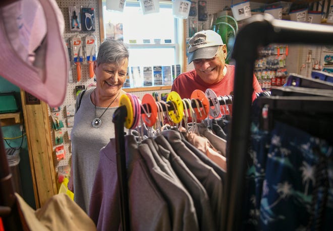 Carol Biagetti (left) and Bob Ferzan, both of Fort Pierce, wander through the T-shirts rack in the souvenir area of Little Jim Bait & Tackle on Tuesday, Nov. 22, 2022, in Fort Pierce. "I just like the peacefulness, the casual atmosphere. It's great, I just love it," Biagetti said.