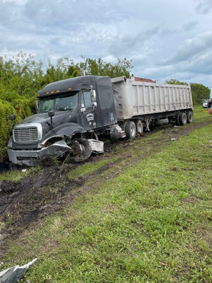 A tractor trailer sits on the side of Southeast Bridge Road after a car collided with it in Hobe Sound Dec. 20, 2022.