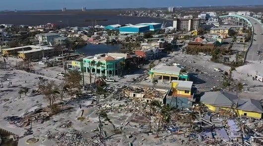 In the Know: Fort Myers Beach damage after Hurricane Ian's devastation. Times Square was at the bottom center. Holiday Court villas had been in the gap between the two yellowish buildings on the left of the image. Clipped and edited from USA TODAY Network video footage.