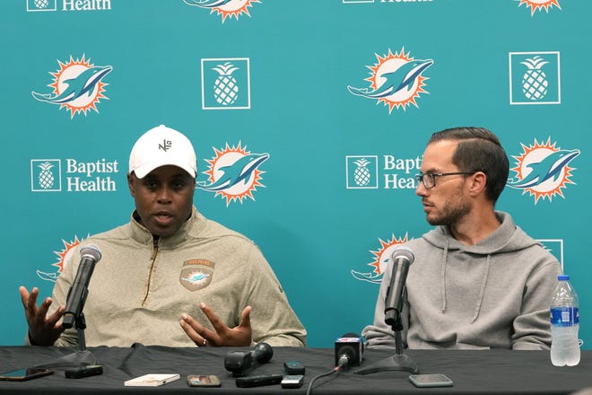 Miami Dolphins general manager Chris Grier, left, and head coach Mike McDaniel, right, respond to questions during a news conference at the NFL football team's training facility, Monday, Jan. 16, 2023, in Miami Gardens, Fla. (AP Photo/Lynne Sladky)