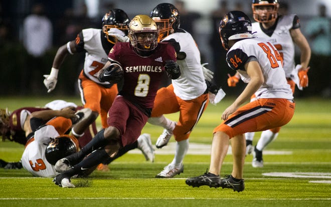Florida High running back Micahi Danzy (8) dodges the Cocoa defense as the Seminoles face the Tigers in the 2022 2S state championship at Gene Cox Stadium on Friday, Dec. 9, 2022 in Tallahassee, Fla. If the FHSAA had an Open Division for schools with an enrollment under 1,500 students, Florida High would have been in the Open Division and Cocoa would remain in 2S.