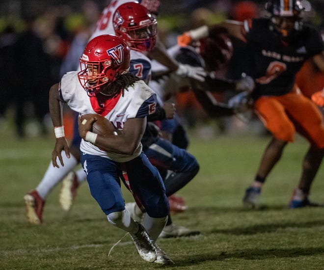 Vanguard (5) Fred Gaskin scrambles out of the pocket during first half action In Lake Wales Fl  Friday November 18,2022.
Ernst Peters/The Ledger